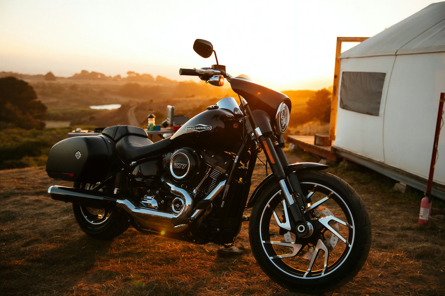 Black Harley-Davidson motorcycle parked on a dirt road.